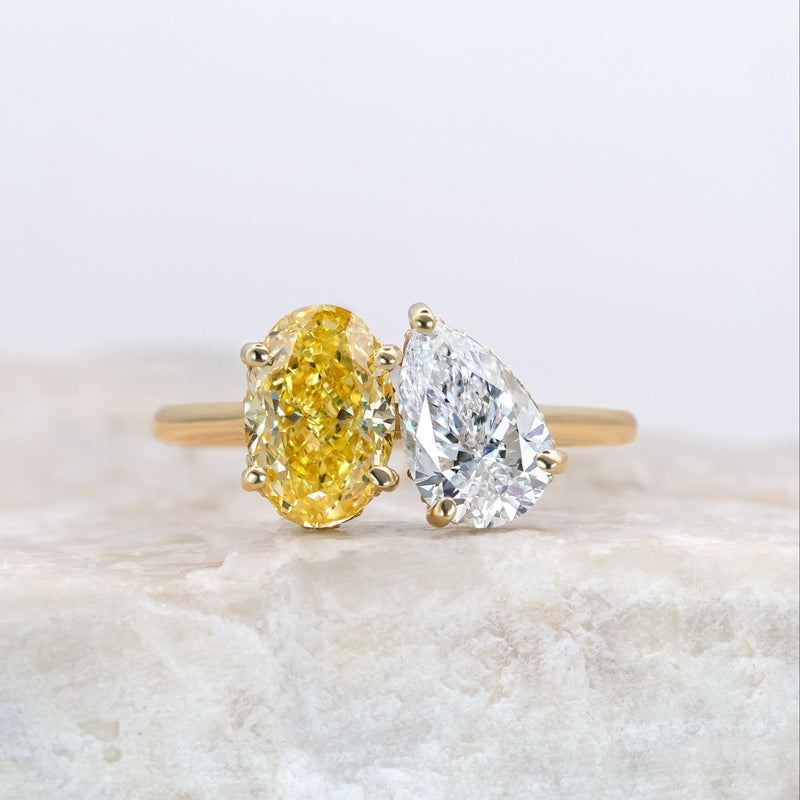A toi et moi style ring with yellow gold band a yellow diamond