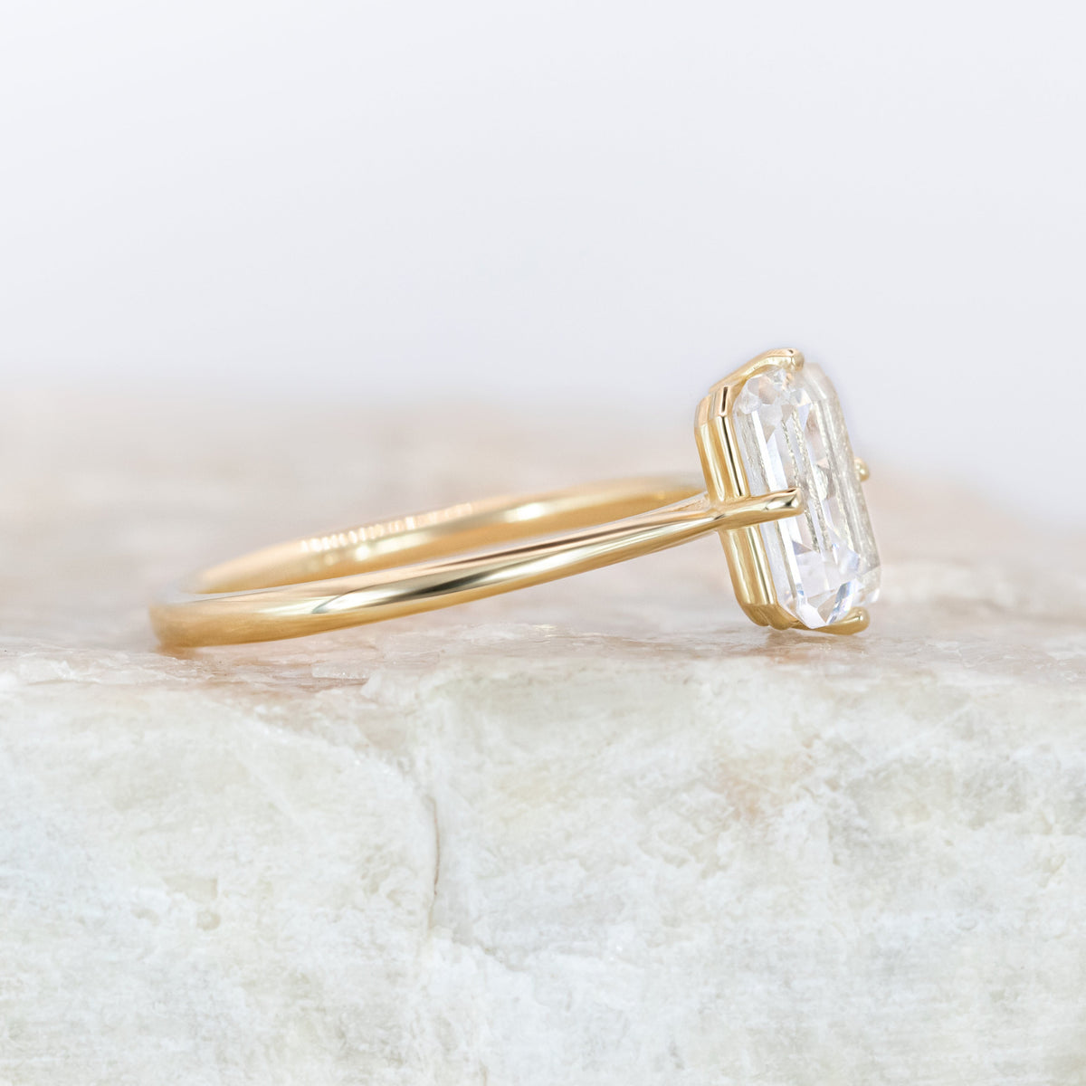Emerald cut diamond with compass prongs