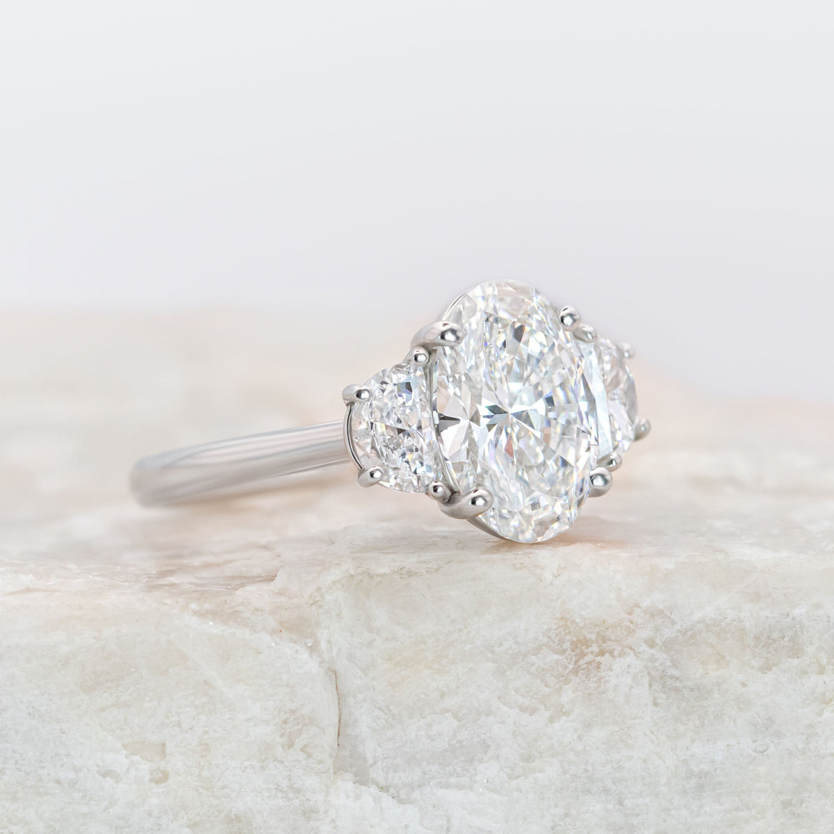Platinum Oval Diamond Ring with Half-Moon Side Stones