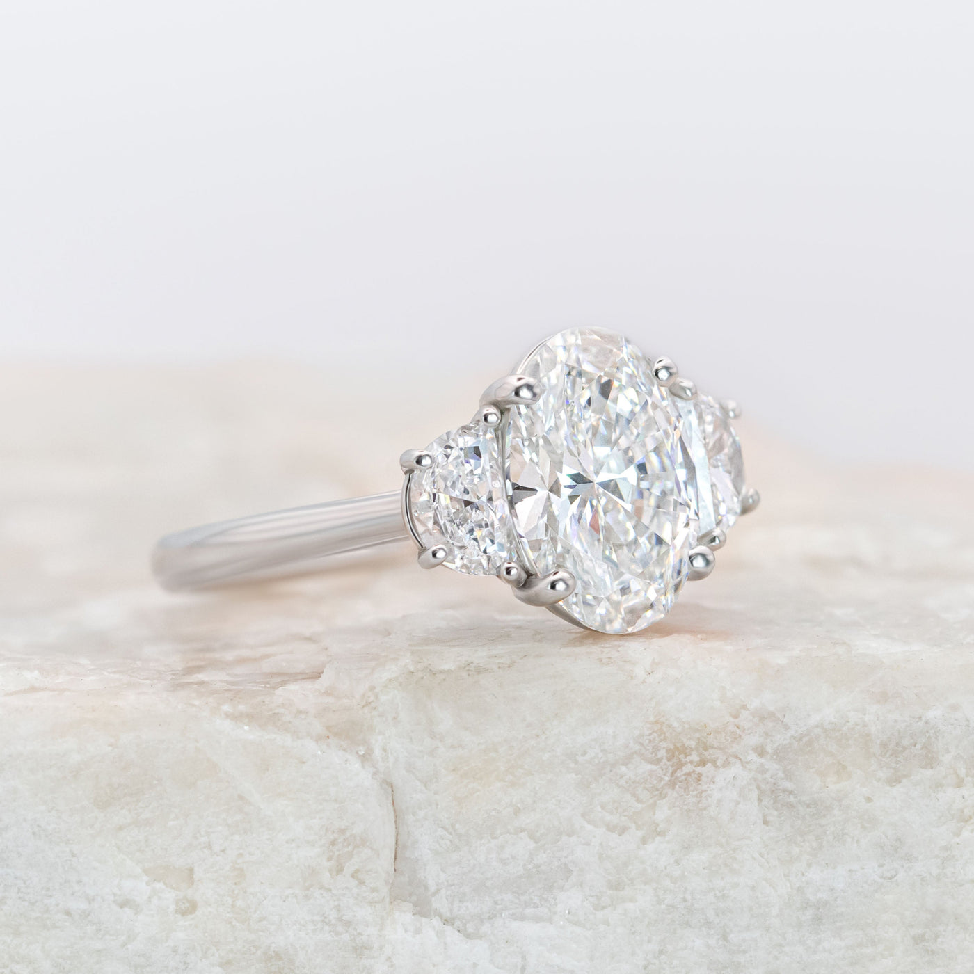 Platinum Oval Diamond Ring with Half-Moon Side Stones