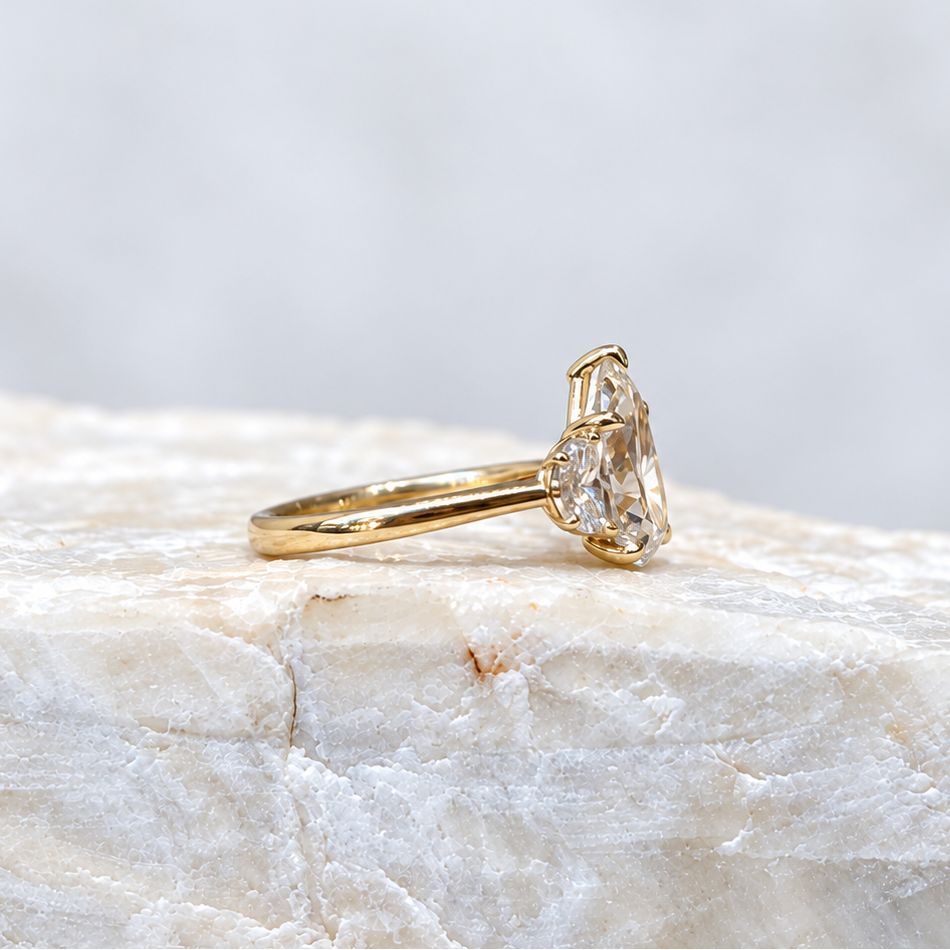 Mary ~ Pear Cut Half-Moon Three Stone Ring