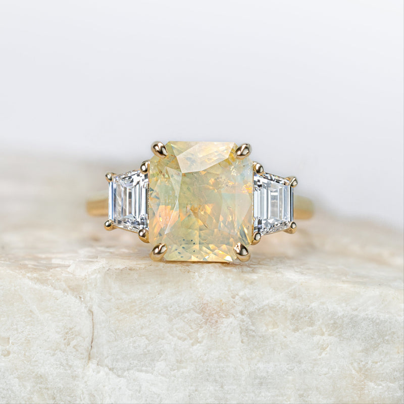 Ring with a large yellow gemstone on a light background