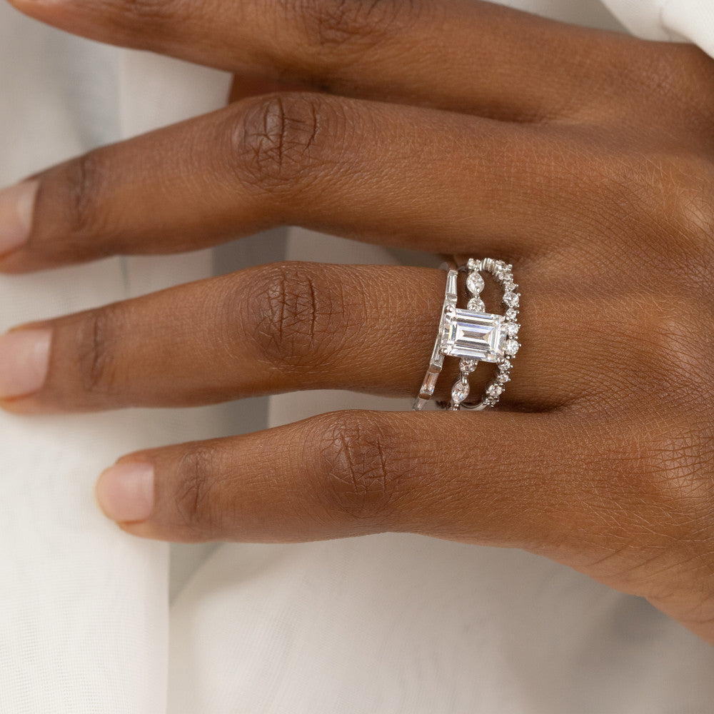 Coco emerald cut side stone engagement ring
